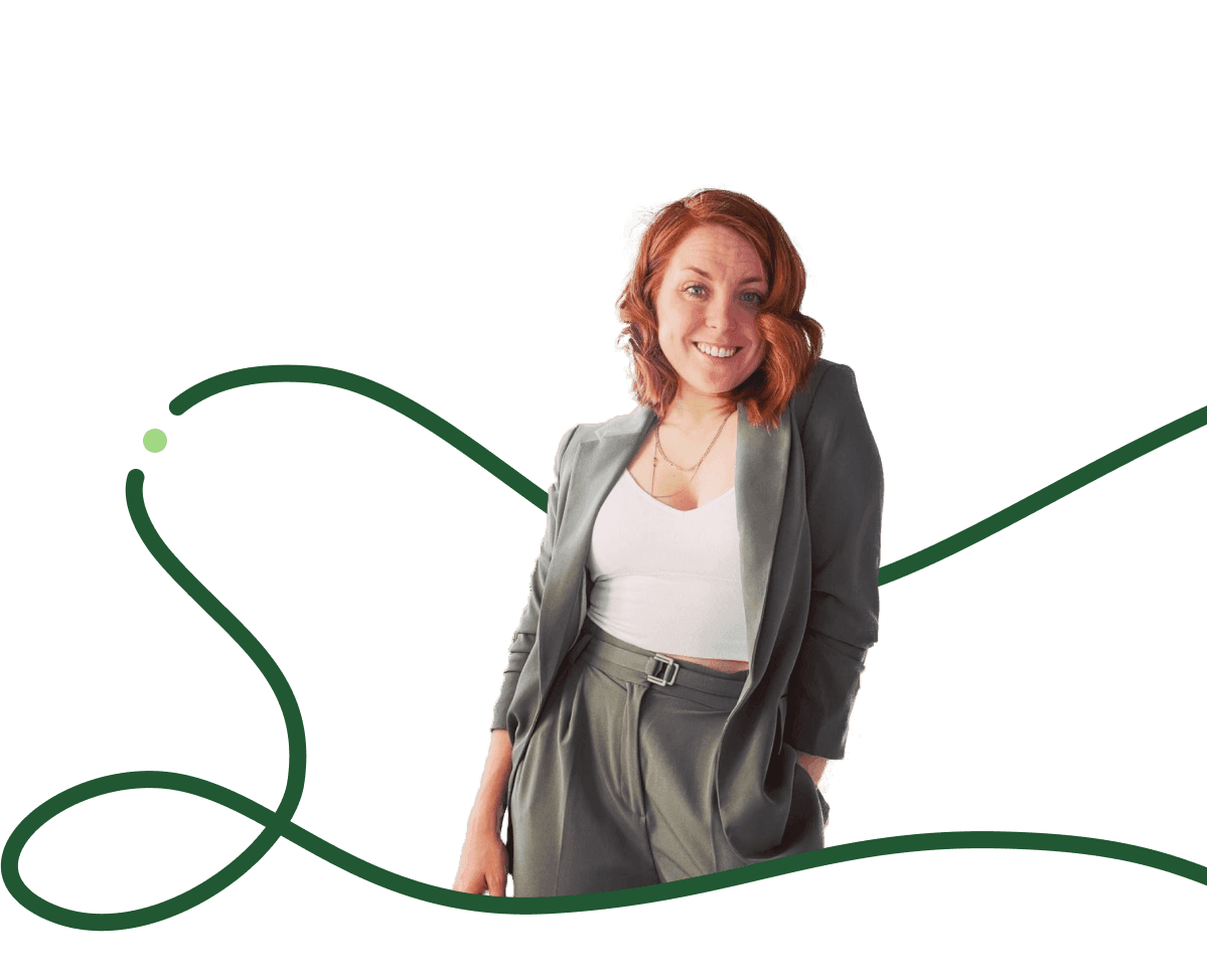 Confident life coach standing in blazer – Empowering clients to create lasting habits and transform their daily routines.